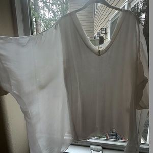 100% silk boxy top. Has stretchy tank attached underneath. Made in Italy Size L